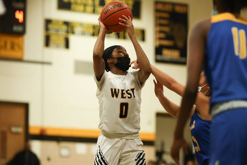 Joliet West’s Lisa Thompson draws the foul taking a shot against Joliet Central. Tuesday, Feb. 8, 2022, in Joliet.