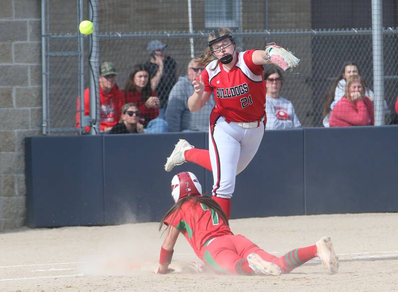 L-P's Callie Mertes slides into first base as the ball sails over the head of Streator's Joyce Walking during the Class 3A Regional semifinal game on Tuesday, May 27, 2025 at Pontiac High School.