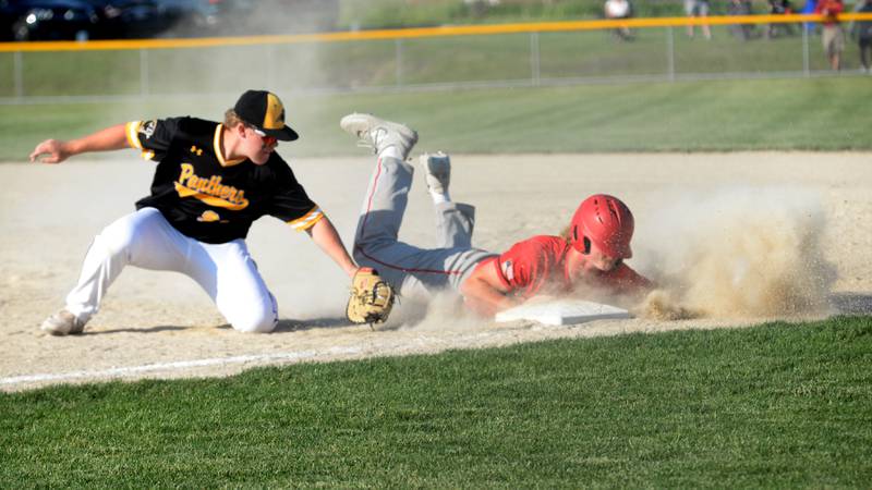 Forreston's Ethan Bocker dives back safely to first against Lena-Winslow at the 1A Forreston Sectional on Wednesday, May 22, 2024.