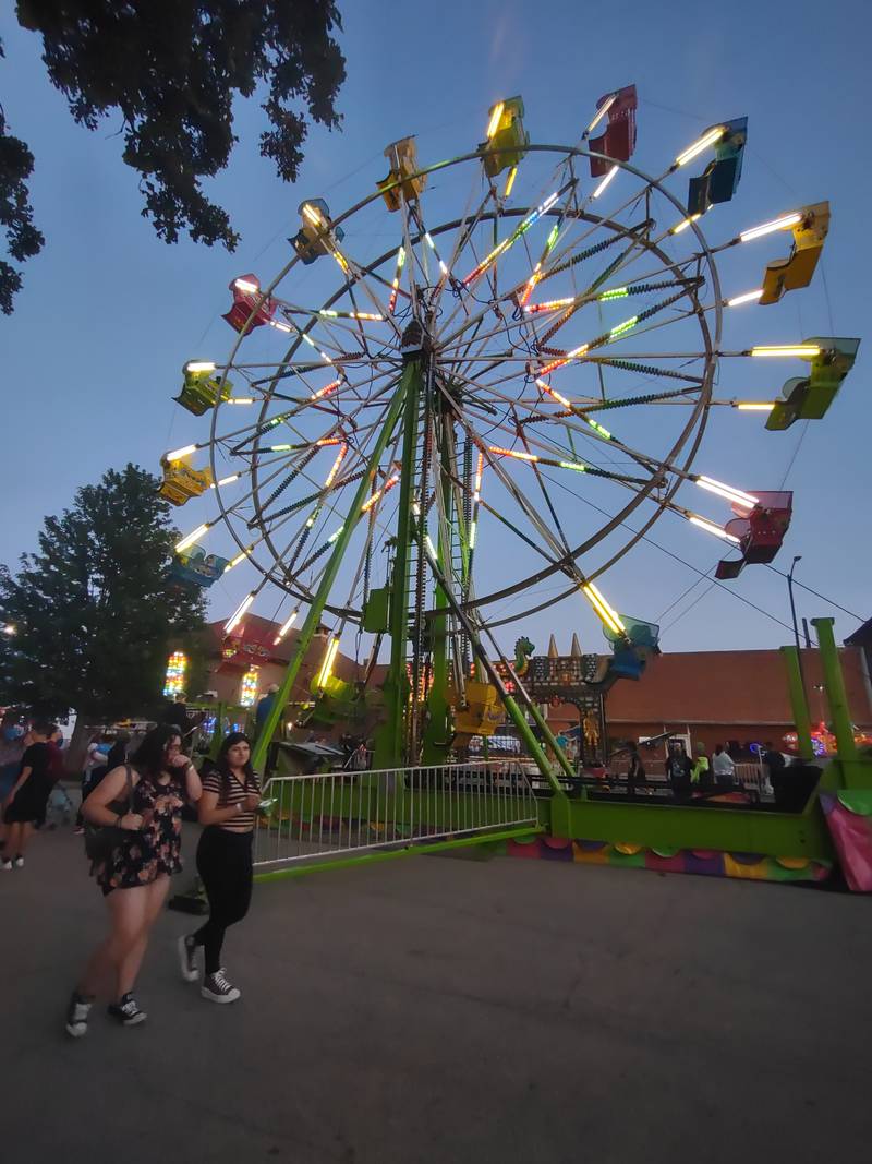 Carnivalgoers stroll the fairway on Hickory Street during the opening night of Park Fest on Friday, May 26, 2023, in downtown Streator.
