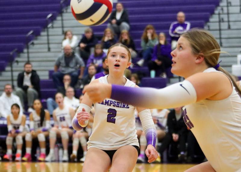 Hampshire’s Ella Ingve, back watches as Hailey Homola plays the ball against Libertyville in an IHSA volleyball Class 4A Sectional Championship at Hampshire High School in Hampshire on Thursday, November 6, 2025.