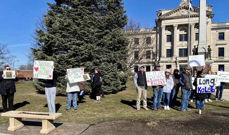 More than three dozen people gather, many holding “Justice for Kaleb McCall” signs outside the DeKalb County Courthouse, 133 W. State St. in Sycamore Wednesday, Feb. 14, 2024. The group gathered to show support for McCall's family as they attended the latest court hearing for a 16-year-old, McCall's Sycamore High School classmate, charged with murder in McCall's slaying.