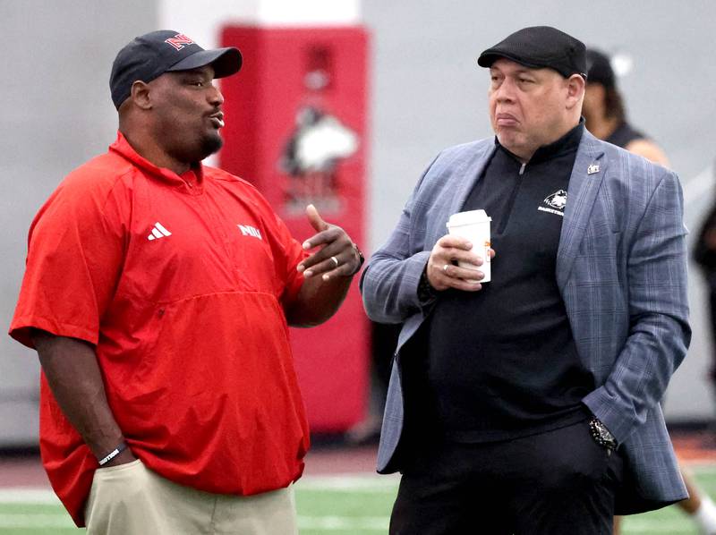 Northern Illinois University football head coach Thomas Hammock (left) talks to NIU vice president and director of athletics, and recreation, Sean Frazier during pro day Monday, March 17, 2025, in the Chessick Practice Center at NIU in DeKalb.