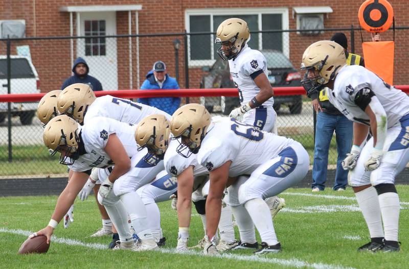 Members of the Marquette football team line up to the ball while playing Gibson City-Melvin-Sibley during the Class 1A playoff game on Saturday, Nov. 1, 2025 at Gibson City-Melvin-Sibley High School.