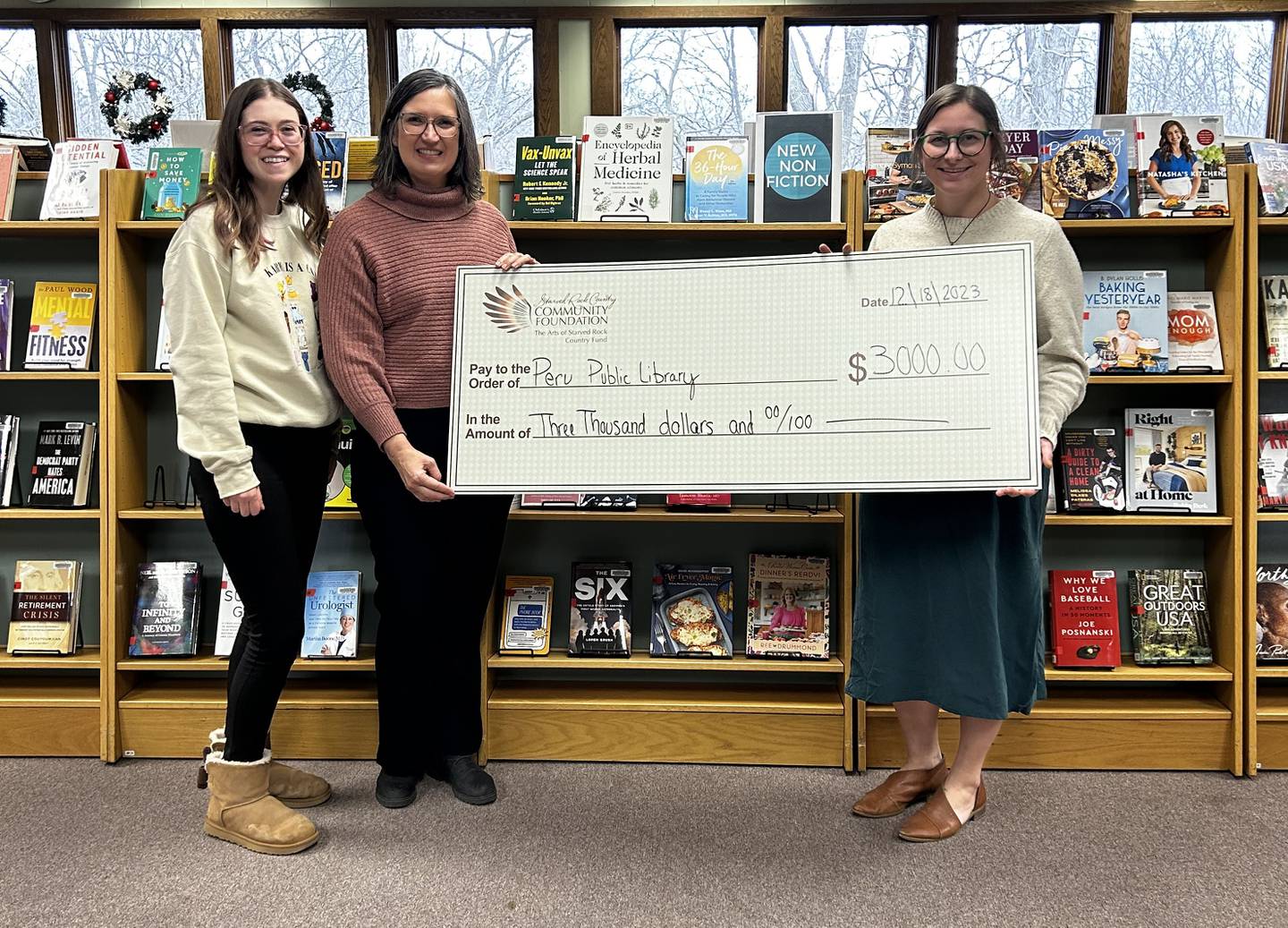 Peru Public Library recently received a $3,000 grant from the Arts of Starved Rock Country fund for its summer reading program. Youth Services Manager Mackenzie Kavanaugh (left) and Program Librarian Marti Pack are pictured with Arts of Starved Rock Country Administrator Amanda Zehr.