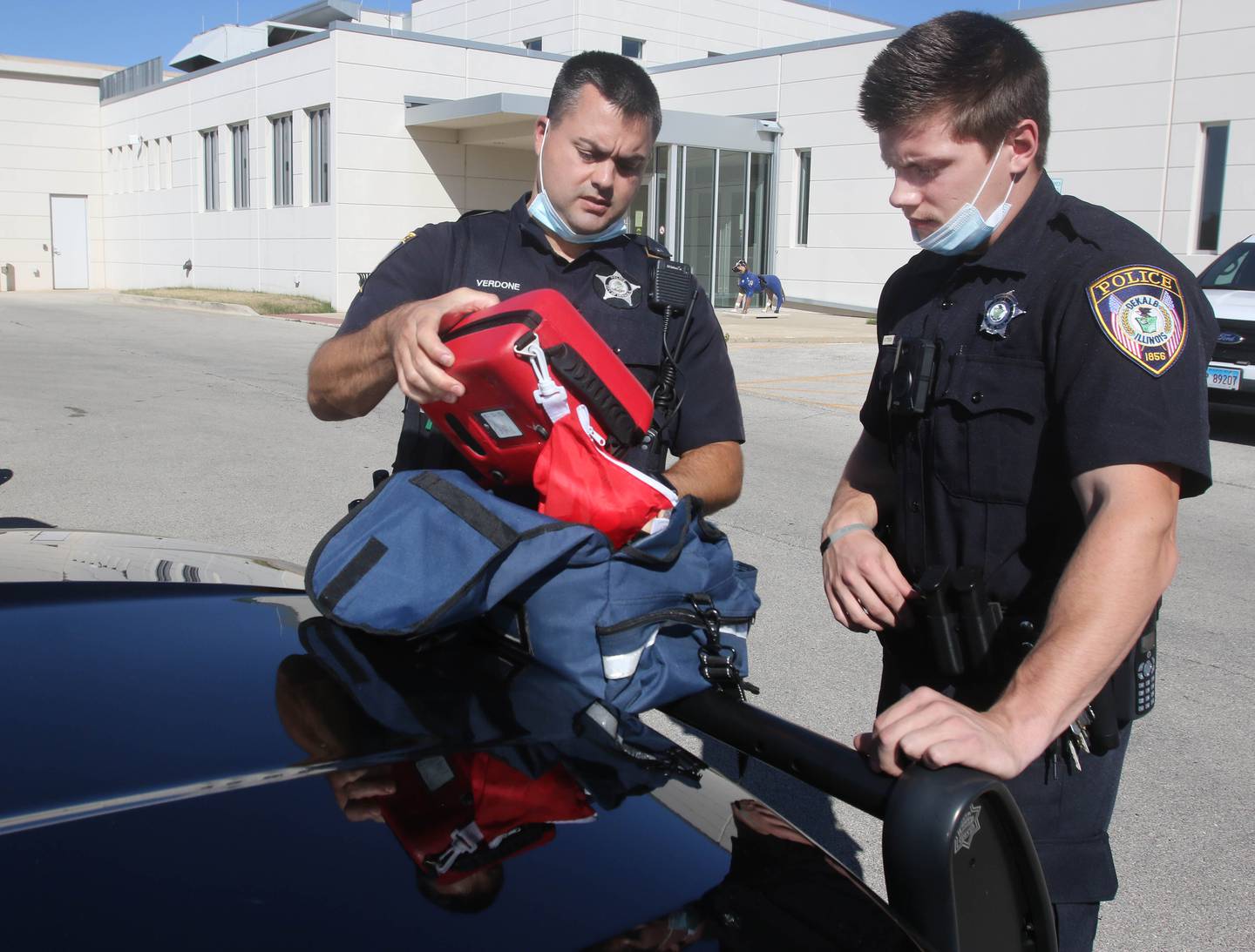 Shaw Local file photo - DeKalb Police Officer Charles Verdone (left) shows new trainee officer Hayden Pattersen the contents of the medical bags they carry in their patrol cars Tuesday, Sep. 28, 2021 in DeKalb.