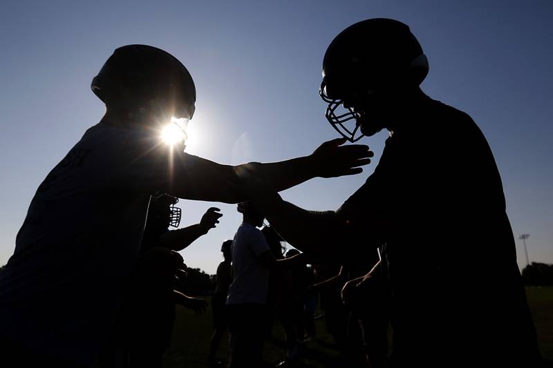 Crystal Lake Central’s Tommy McNeil and Nick Kozlowski hand fight during football practice Tuesday, July 11, 2023, at Crystal Lake Central High School .
