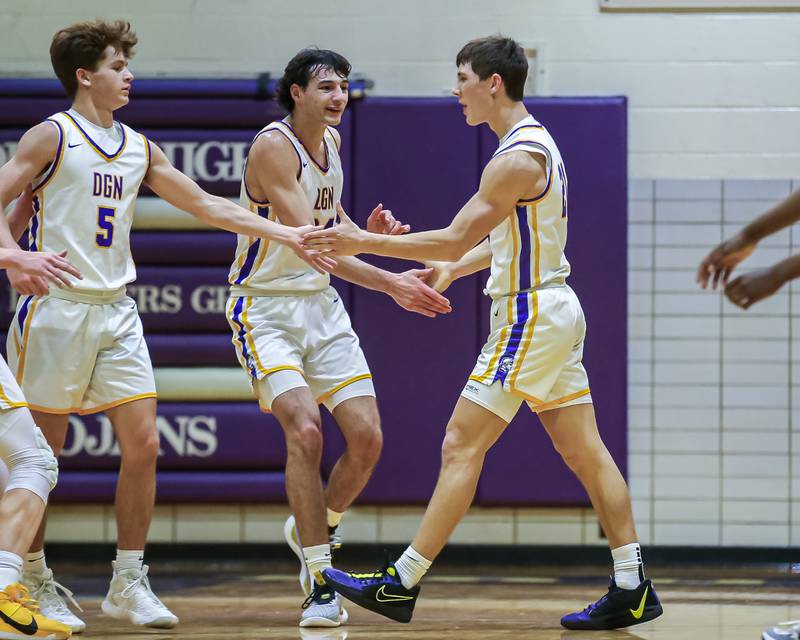 Downers Grove North's Jack Stanton (21) celebrates getting fouled on a three point shot during basketball game between Downers Grove South at Downers Grove North. Dec 16, 2023.