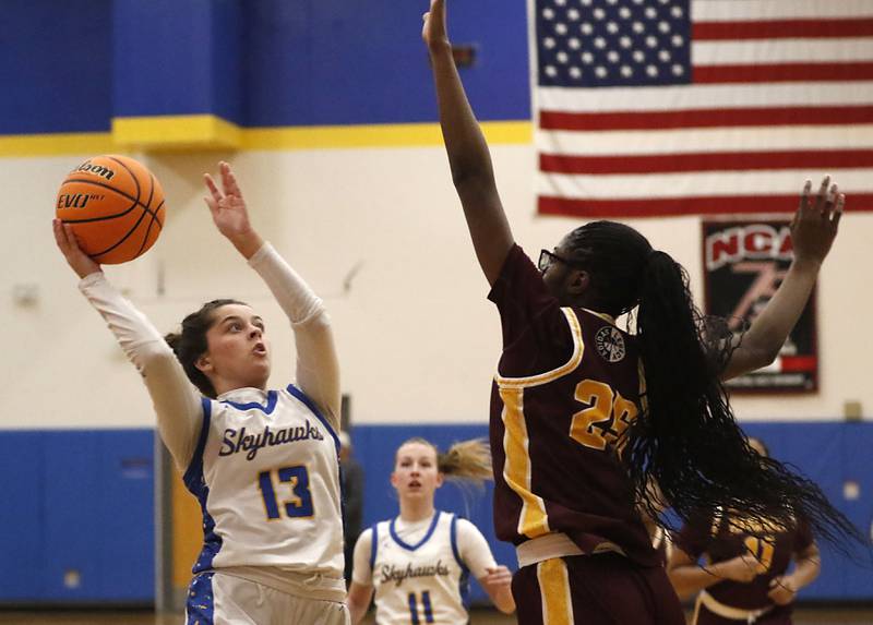 Johnsburg's Lauren Mcquiston shoots the bal over Chicago Marshall's Chamarre Scott during a IHSA Class 2A Johnsburg Sectional girls basketball semifinal game on Tuesday, February, 24, 2026, at Johnsburg High School.