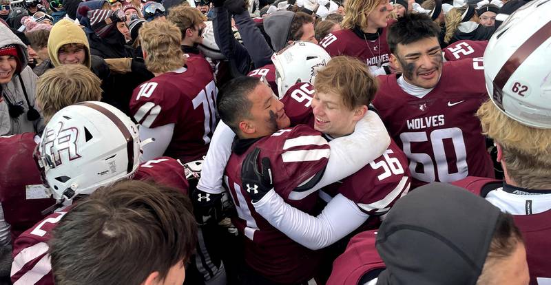 Prairie Ridge players and fans celebrate a Class 6A football playoff semifinal win at Crystal Lake on Saturday. The Wolves advanced to the state title game with their win over St. Ignatius.