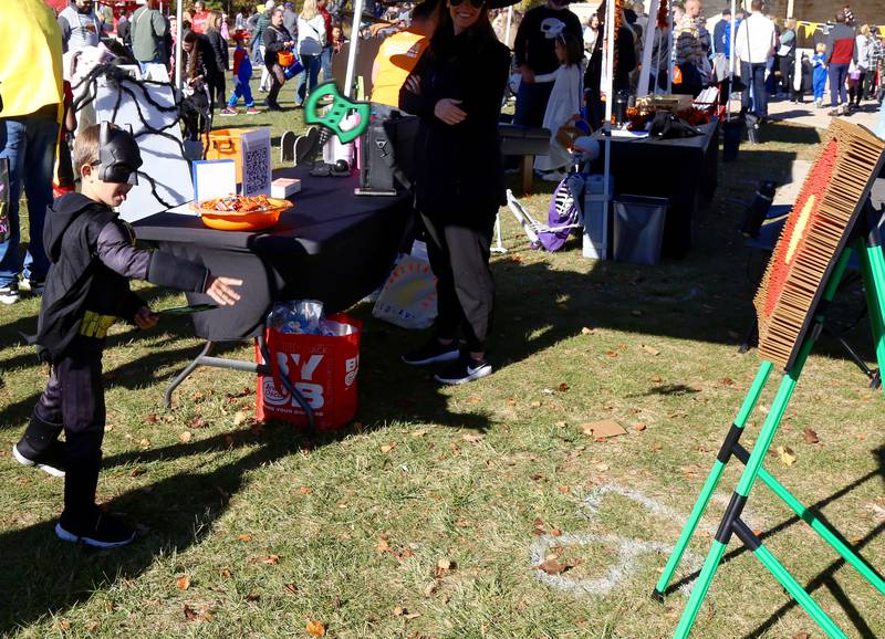 Luke Lorden, 6, of Batavia tries his hand at axe throwing at Batavia Bat Fest on Saturday, Oct. 26, 2024.