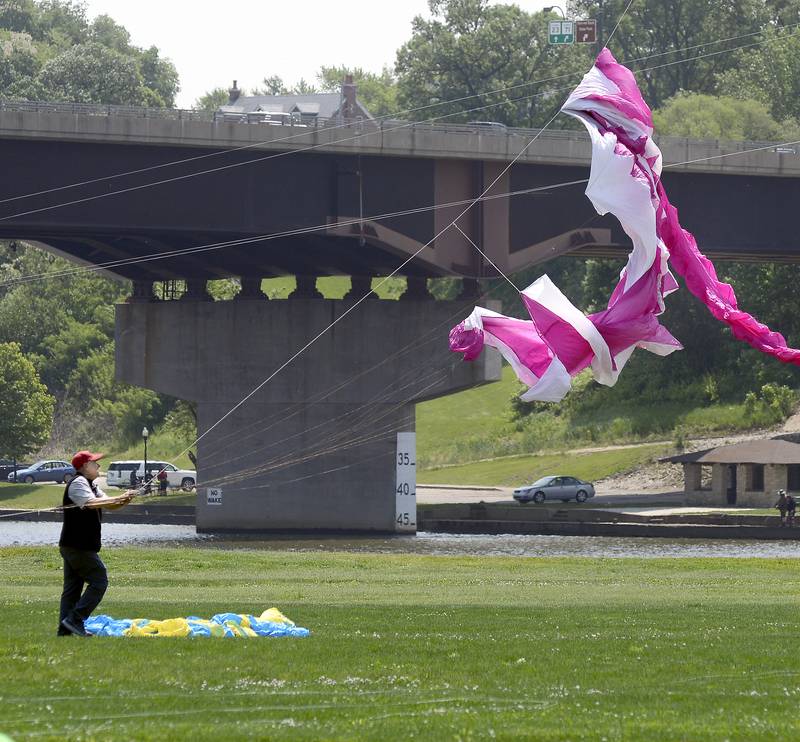 Mike Holl works to untangle his kite Saturday, May 20, 2023, at Riverfront Park in Ottawa during the Kites in Flight festival.