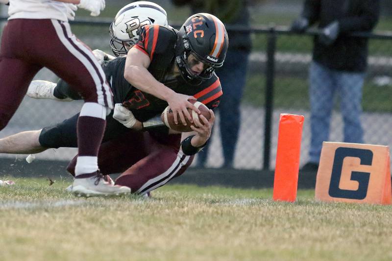 Crystal Lake Central quarterback Colton Madura dives for the endzone on a play that resulted in a first down but no touchdown due to a flag on the play during their football game against Prairie Ridge at Crystal Lake Central High School on Thursday, April 1, 2021 in Crystal Lake.