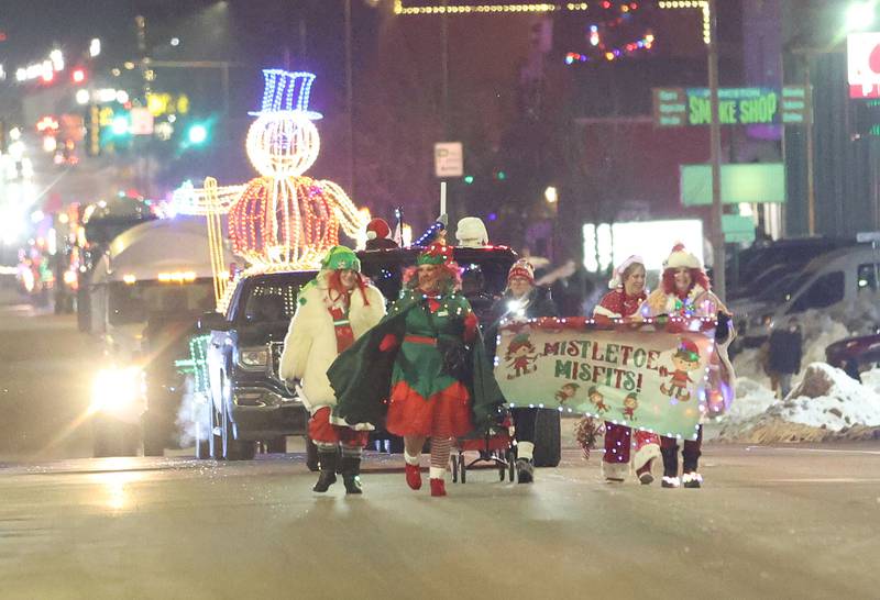 The Mistletoe Misfits walk Santa during the "Night of Lights" parade on Friday, Dec. 5, 2025 downtown Princeton. The event featured the Christmas tree lighting at Veterans Park a lighted Christmas parade down Main Street,  Living Windows, a Candy Cane Hunt, and visits with Santa.