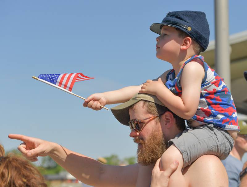 Martin Benson, 4 sits on his dad Charlie’s shoulders to get a better view during the annual St. Charles Memorial Day Parade on Monday, May 29, 2023.