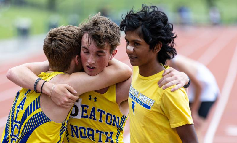 Nathan Carroll, left, and Sarin Hanoman, right, hug their teammate Reid Goerzen after he completed the freshman and sophomore 3200 meter race at the Dukane Conference Boys Track and Field Meet hosted by Lake Park High School in Roselle on Friday, May 16, 2025. Goerzen placed 6th and Caroll placed 5th.