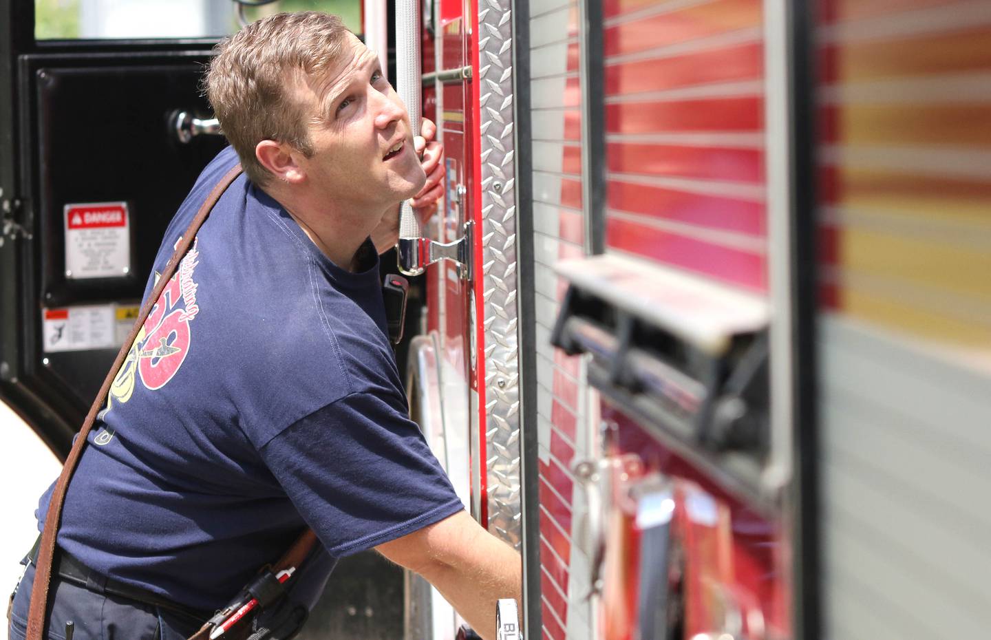 Shaw Local file photo - Travis Karr, firefighter/paramedic with the DeKalb Fire Department, gets one of the trucks ready to put back in the bay on May 21, 2021 at Fire Station No. 3 in DeKalb.