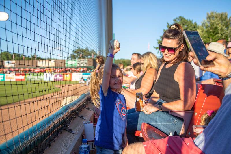 Josie Valenti, 3, of Woodridge poses for a photo with a game used ball during the Kane County Cougar's game against the Milwaukee Milkmen at Northwestern Medicine field on Friday, July 29, 2022.