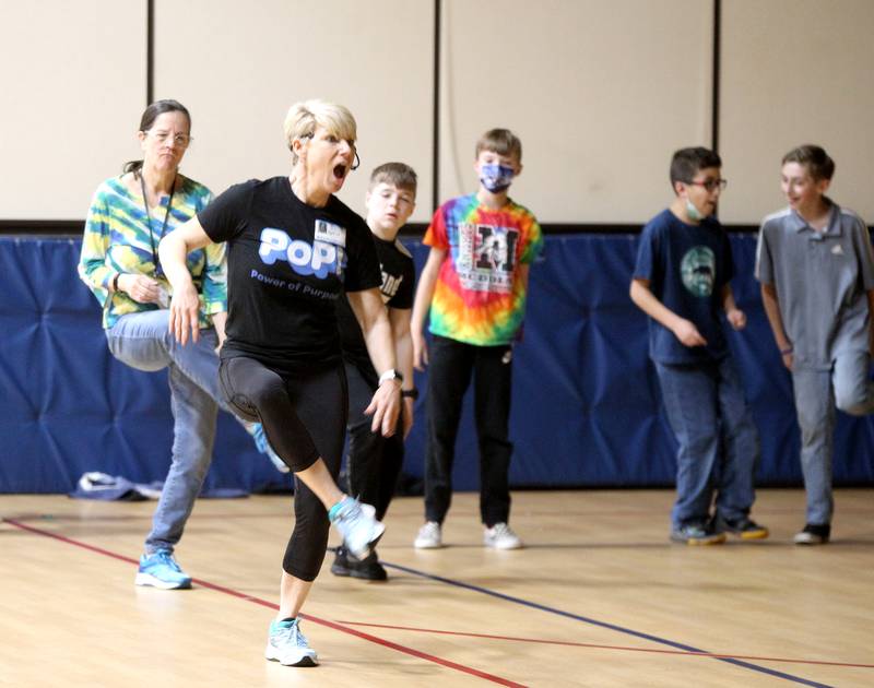 Susie Lah, of PoP! Power of Purpose, leads Kaneland McDole fifth graders in a dance party and celebration of a recent fundraiser at the school on Friday, March 25, 2022. Students raised over $33,000 to benefit Feed My Starving Children, A.D.O.P.T. Pet Shelter and the school’s physical education department.