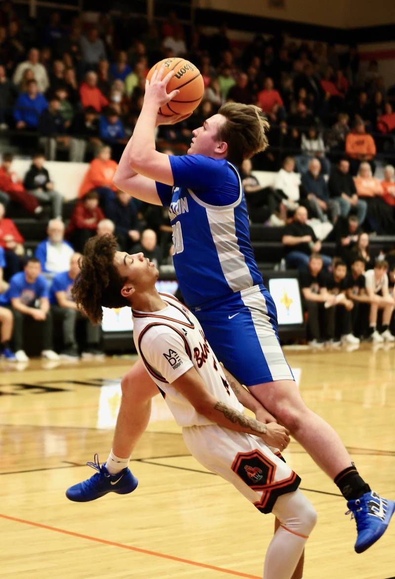 Princeton's Jordan Reinhardt takes a ride over Kewanee's Catrelle Reed in Friday's Three Rivers East game in Kewanee. The Tigers won 69-60.