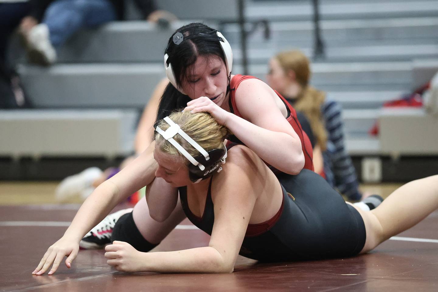 Ottawa’s Mary Rodriguez works over Morris’ Harper Hanson in the 170 pound match on Wednesday, Dec. 10, 2025 in Morris.