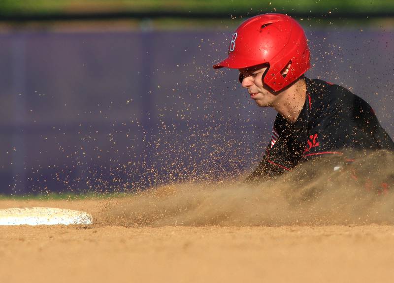 Barrington’s Dylan Koehler slides safely at second base against Huntley in sectional semifinal baseball action at Hampshire Wednesday.