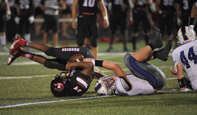 Barrington’s Calvin Jackson is tackled by Warren’s Aiden Porreca at Barrington High School Friday, August 25, 2023.