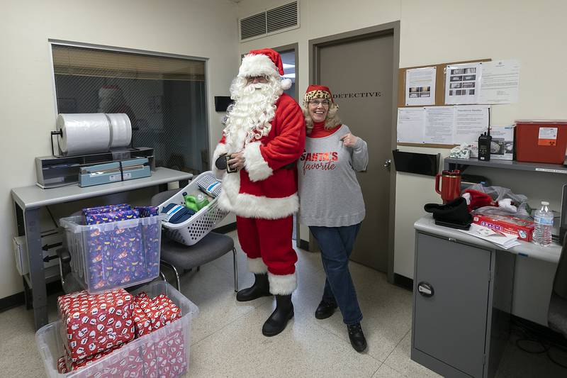 Jon and Joy Colbert, aka Mr and Mrs. Claus, prepare the gifts for delivery Monday, Dec. 23, 2024. The department collected $8,000 in donations from the community for the project.