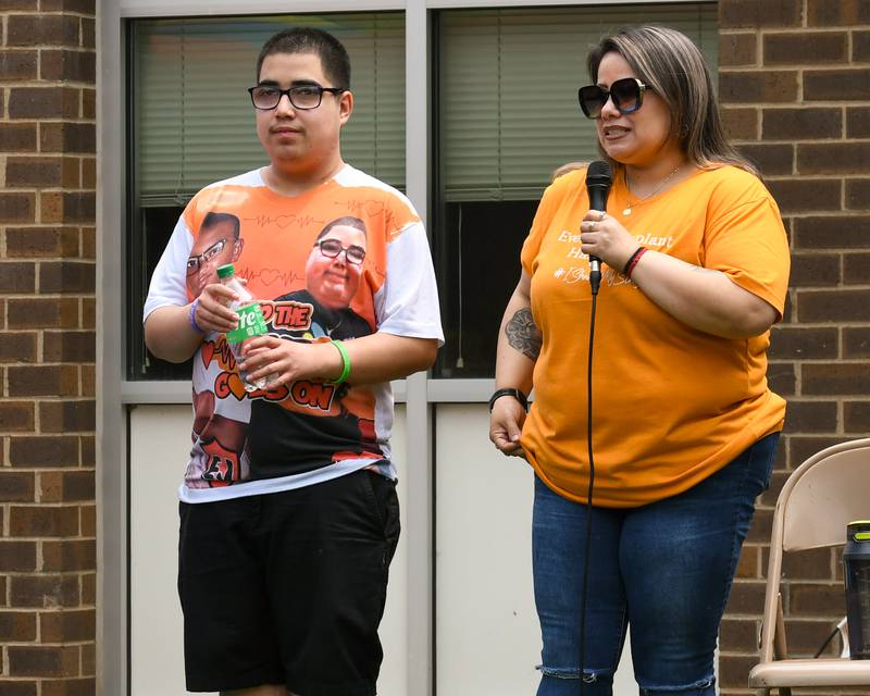 Georgina Peña (right) speaks alongside her son Andy Valtierra, of Little Rock, on Saturday, June 7, 2025, during the Ezra Hill Jr. Memorial Foundation’s 5th annual rock painting event held at Tyler Elementary School in DeKalb. The foundation was created to memorialize the late DeKalb boy, shot and killed in 2019. Andy was the organ donor recipient of Ezra's heart, donated after his death.