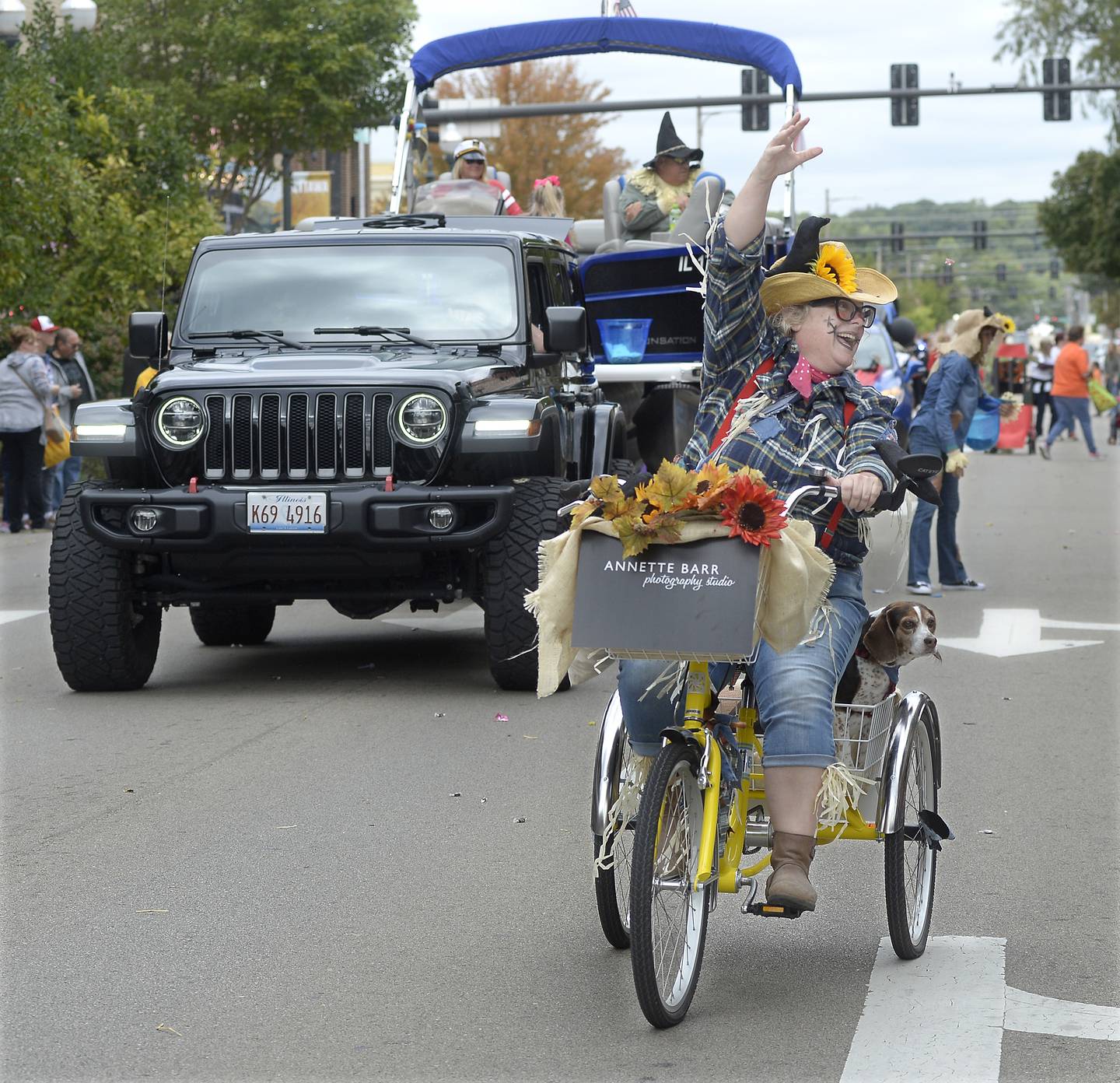Dressed in her scarecrow finest, Annette Barr tosses candy to the crowd along La Salle Street in Ottawa during the scarecrow parade Sunday, Sept. 25, 2022.