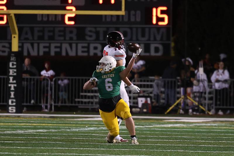 Providence’s Jon Fotsis holds up the ball after an interceptions that secured a win against Lincoln-Way Central on Friday, Sept. 6, 2024 in New Lenox.