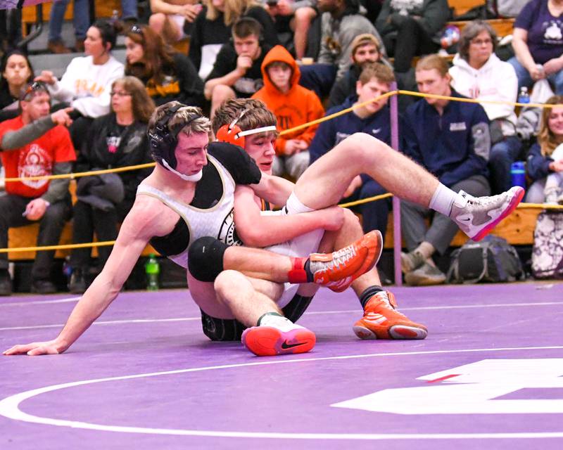Sycamore Zack Crawford, left, and Crystal Lake Central wrestler Ben Buter get tangled up during the 2A 160 weight class sectional championship match up where Ben took the victory on Saturday Feb. 11th held at Rochelle High School.