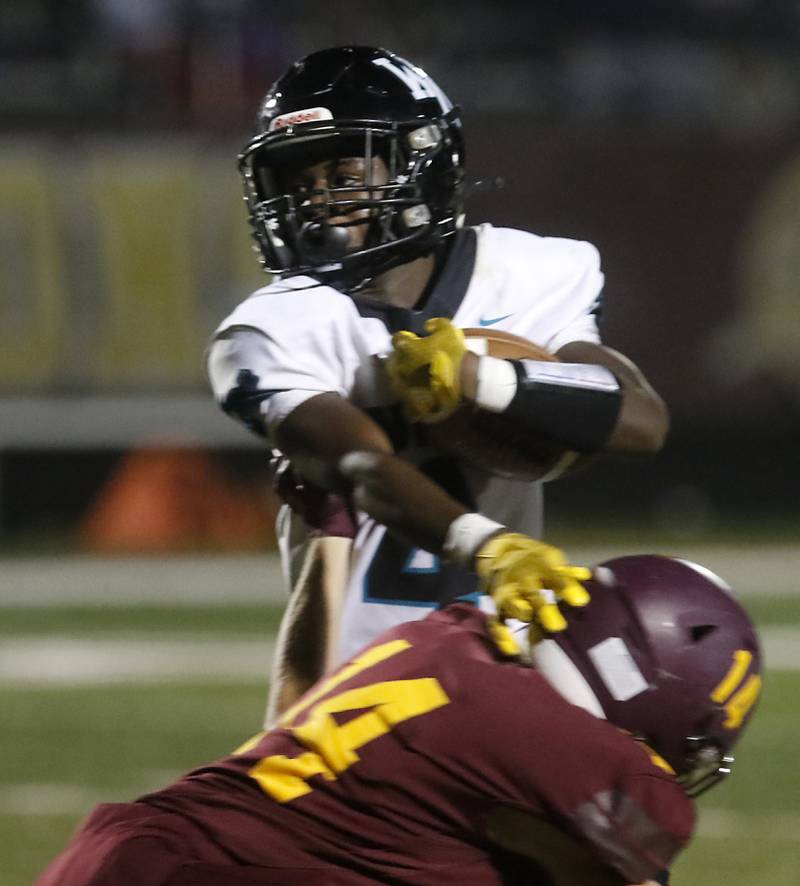 Woodstock North's Sean Mitchell tries to cut back against Richmond-Burton's Logan Molczan during a Kishwaukee River Conference football game on Friday, Oct. 11, 2024, at Richmond-Burton High School.