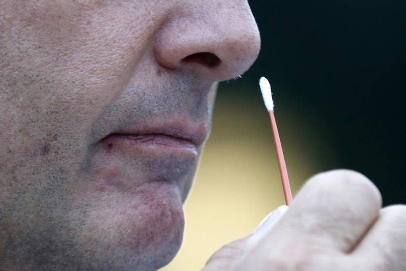 Ed Jost has a COVID-19 test sample collected by Curative Testing Specialist Tod Schneider at the weekly COVID-19 testing site for D-15 staff on Monday, Sept. 20, 2021 at Hilltop Elementary School in McHenry.