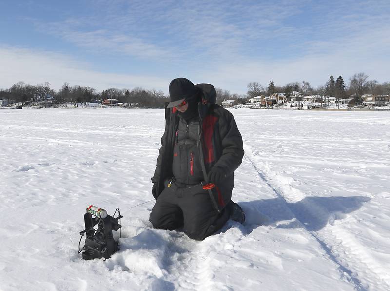 Trevor Janes, who owns Wet N Wild Outfitters, ice fishes Friday, Feb 3. 2023, on Petite Lake near Fox Lake.