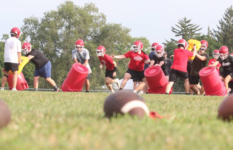 Members of the Hall high School football team run drills during camp on Thursday, July 24, 2025 at Hall High School.