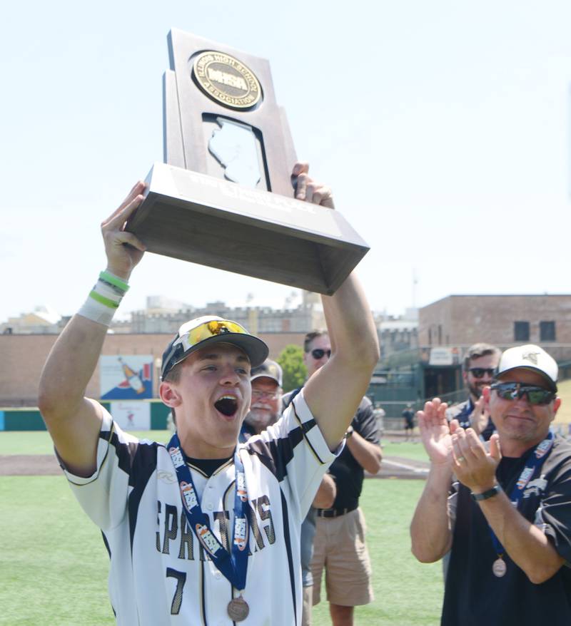 Joe Lewnard/jlewnard@dailyherald.com
Sycamore’s Kiefer Tamoki holds his team’s trophy following the Spartans’ 2-1 win in nine innings over Effingham during the Class 3A  third-place state baseball game in Joliet Saturday.