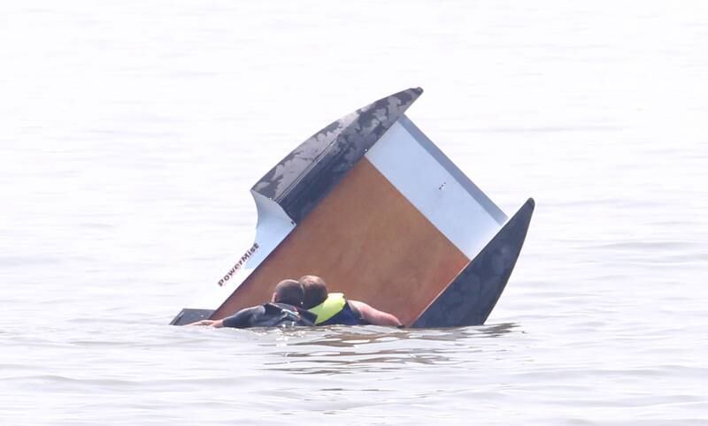 Safety crews help flip Nick Hooten's boat around after it capsized during the US Title Series Pro National Championship Boat Races on Friday, July 26, 2024 at Lake DePue.