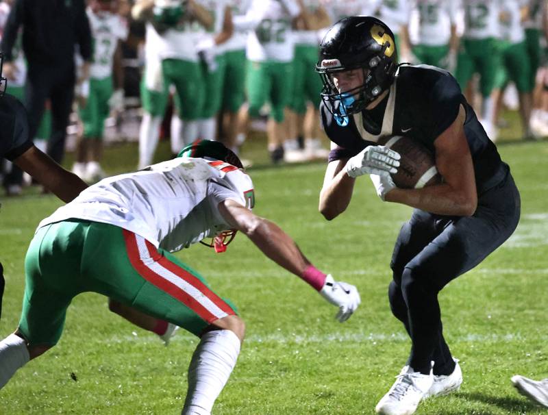Sycamore's Benjamin Anderson prepares for contact with La Salle-Peru's Regan Doerr during their game Friday, Oct. 10, 2025, at Sycamore High School.