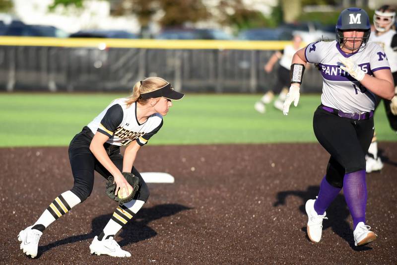 Herscher's Emma Powers, left, fields a ground ball as Manteno's Bella Gigliello runs to third base during a game in Herscher on April 29, 2024.