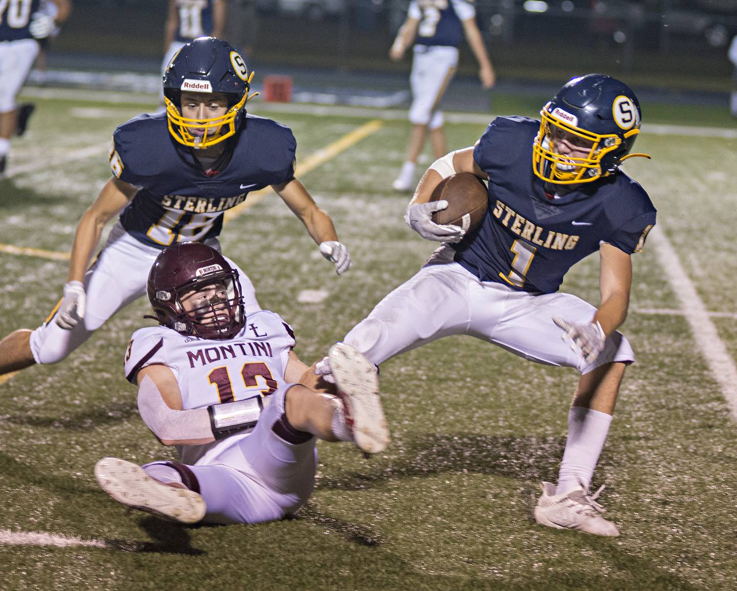Sterling's Tommy Tate is pulled down for a loss by Montini's Luke Pacelli Friday, September 3, 2021.