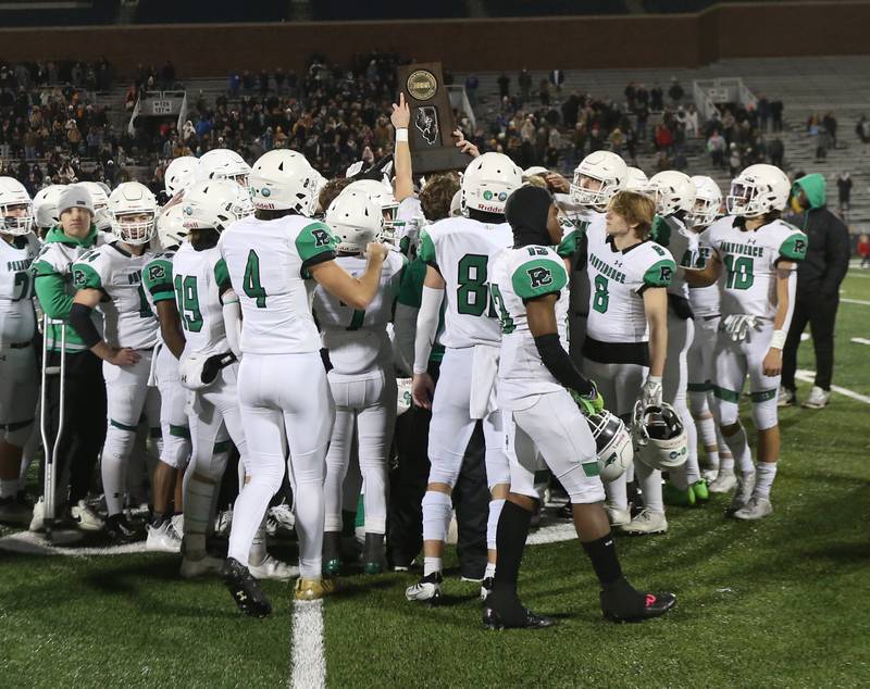Providence Catholic players hoist the second place trophy after loosing to Sacred Heart-Griffin in the Class 4A state title on Friday, Nov. 25, 2022 at Memorial Stadium in Champaign.