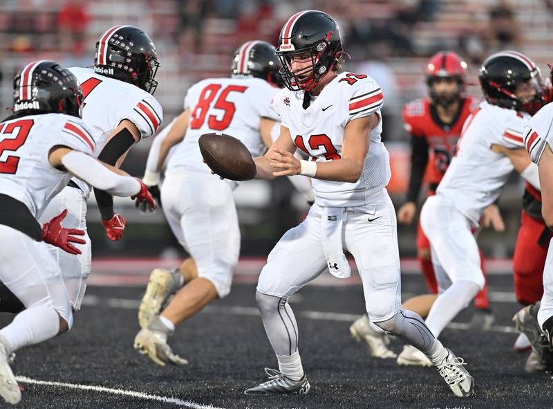 Lincoln-Way Central's Michael Kuehl hands off the ball during a non-conference game against Bolingbrook on Friday, Sep. 29, 2023, at Bolingbrook. (Dean Reid for Shaw Local News Network)