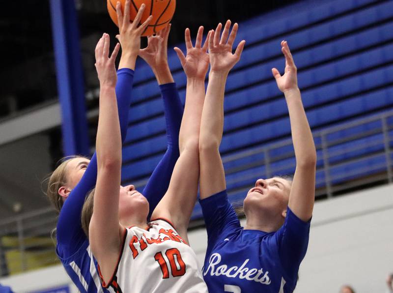 Burlington Central’s Ainsley Wilson, left, and Julia Scheuer, right, battle Crystal Lake Central’s Sammi Pottorff for the ball in IHSA Class 3A Regional Title Game girls basketball action on Thursday, Feb. 20, 2025, at  Central High School in Burlington.