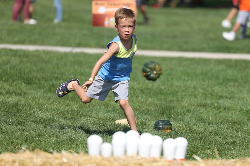 Logan DeLucio, 5-years old, bowls with a gourd at the Autumn Family Fun Fest on Saturday, Sept. 23, 2023 in Plainfield.