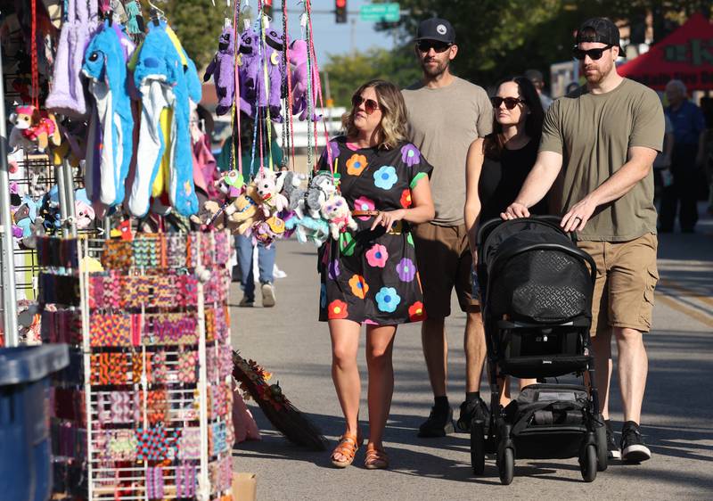 Visitors check out some of the items available at the craft show Friday, Aug. 23, 2024, during the DeKalb Corn Fest.