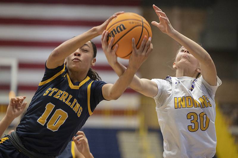 Sterling’s Nia Harris fight for a rebound against Hononegah’s Ainsley Hughes  Saturday, Dec. 21, 2024, during the Sterling Shootout.
