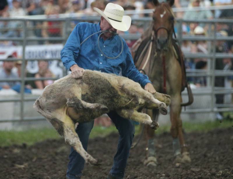 Dave Corcoran of Earlville, competes in the Tie-down Roping during the Broken Horn Rodeo at the La Salle County 4-H Show and Junior Fair on Friday, July 14, 2023 in Ottawa.