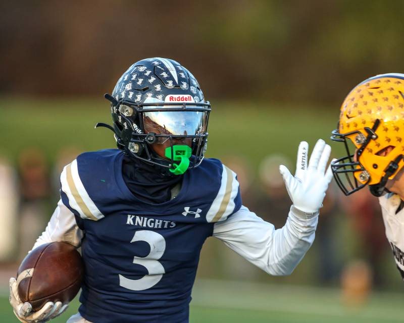 IC Catholic Prep's Kaleb Ellis (3) avoid the defense on a run during Class 4A third round playoff football game between St Laurence at IC Catholic Prep.  Nov 11, 2023.