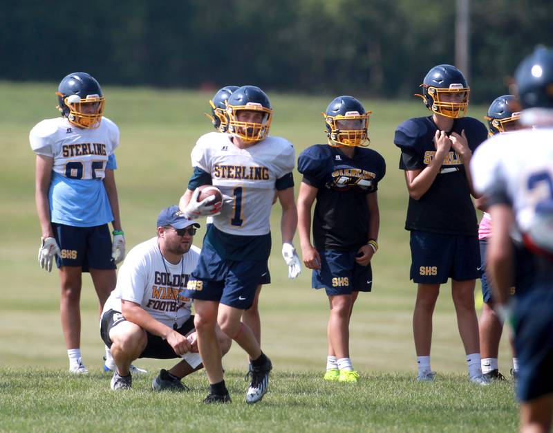 Sterling’s Wyatt Cassens carries the ball during a joint practice with Glenbard South and Oswego East football teams on Tuesday, July 15, 2025 in Oswego.